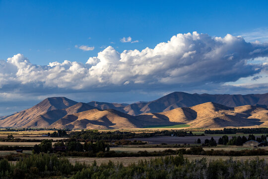 White puffy clouds over mountains