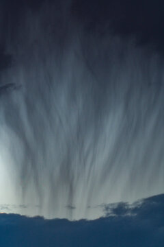 Heavy rain pouring from gray clouds