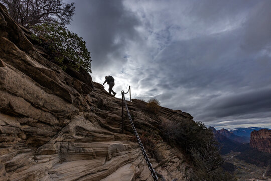 Low angle view of female hiker climbing top of Angels Landing