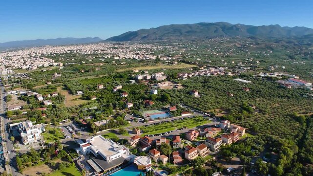 Aerial view of Kalamata coastline with beach, olive groves, city buildings and Taygetus mountains in Peloponnese, Greece