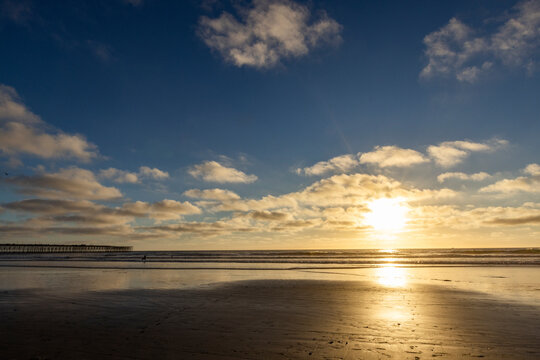 Sun setting over beach and calm ocean