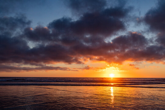 Sun setting over calm ocean