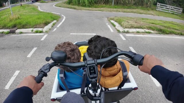 Father riding an electric cargo bike with two children on a dedicated bike path for sustainable family commuting and enjoying an active lifestyle with his kids