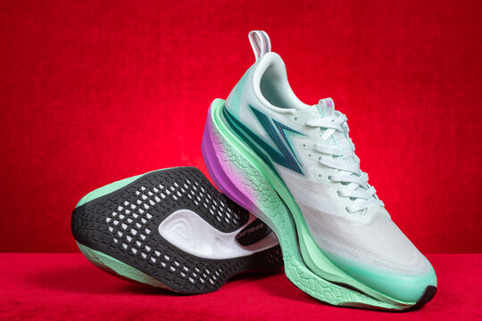 Zhongshan China-March 7 2026: 361 white and green running shoes for boy on red.