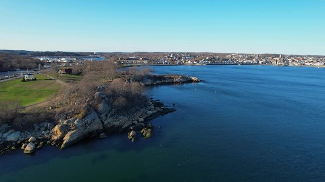 Ascending drone flight in the coast in Gloucester, clear sky and vibrant spring day in Massachusetts, USA