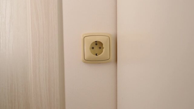 Close-up of newly installed electrical socket outlet on wall in renovated residential apartment.
