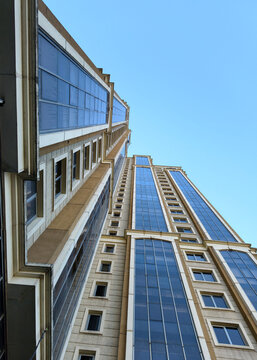 Tall building with modern design reaching towards clear sky