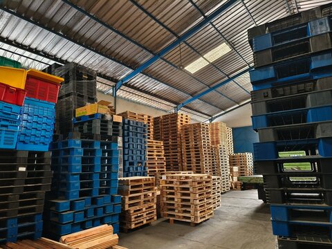 warehouse storage with stacked pallets and crates.