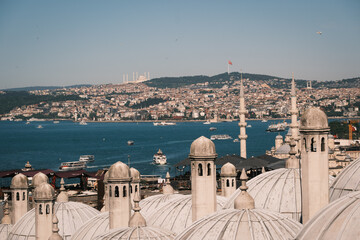 Naklejka premium Panoramic view over Istanbul cityscape and the Bosphorus strait from Suleymaniye Mosque rooftops, showing distant Camlica Mosque on the hill and traditional stone domes, Turkey