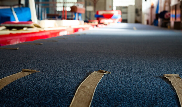 Interior of gym with old exercise machines, parallel bars and pommel horse