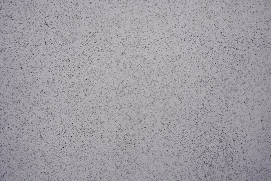 Grey textured surface with small speckles for abstract background design
