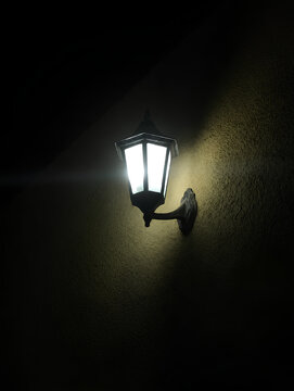 Vintage wall lamp with warm led light on dark rustic texture wall at night