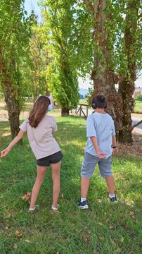 teenagers wearing wireless headphones, and dancing floss dance, or flossing and having fun together