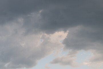 Fototapeta premium Calm sky with soft cloud edges. Drone surveys tranquil scene with gentle clouds and clear horizon. Peaceful aerial view showcasing soft illuminated sky and distant horizon line