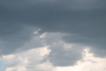 Fototapeta premium Stormy sky tension. Gray clouds signal impending storm. Dark clouds foretell approaching heavy rainfall. Overcast skies with subdued colors hint at oncoming storm activity