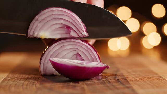 Closeup of a chef slicing a vibrant red onion on a wooden cutting board 1.