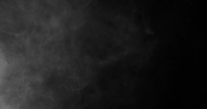 Detailed slow motion rising smoke isolated on black background. Cinematic fog overlay with soft swirling motion, ideal for VFX compositing, transitions and atmosphere.