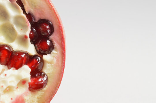 close up of pomegranate against white background and space for text for branding