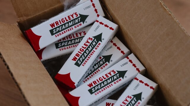 Tambov, Russian Federation - May 22, 2026 Several packs of Wrigley's Spearmint sugarfree chewing gum packed inside an open cardboard shipping box.