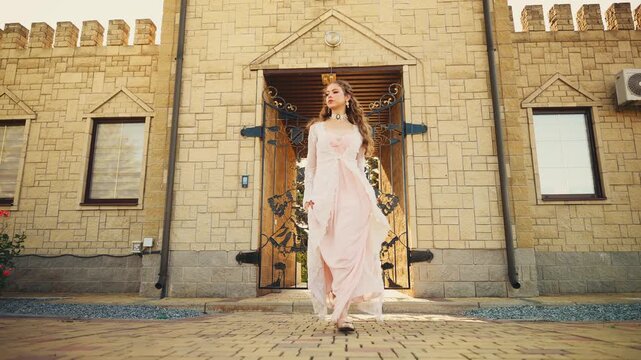 Art portrait Fantasy girl princess happy face long hair runs walks slow motion on old style city street summer nature magic light. middle ages vintage lady cute young woman, white pink lace ball gown