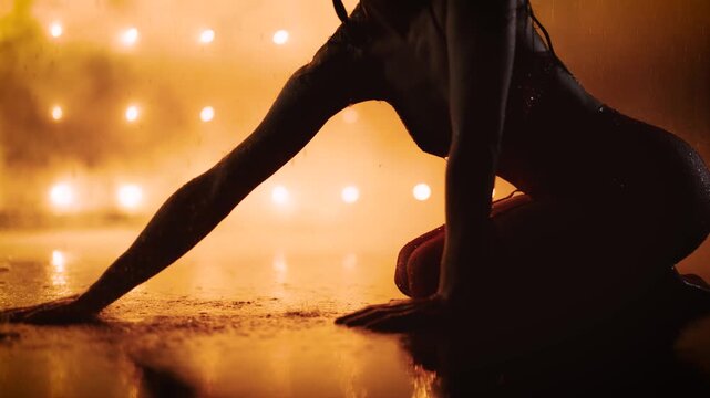 Woman Posing on Wet Floor Under Golden Rain Lighting