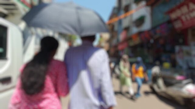 Blurred view of the Main Bazaar street leading to the New Delhi Railway Junction, India, on a sunny day. Motionlapse video for background.