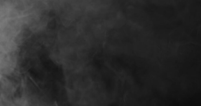 Detailed slow motion rising smoke isolated on black background. Cinematic fog overlay with soft swirling motion, ideal for VFX compositing, transitions and atmosphere.