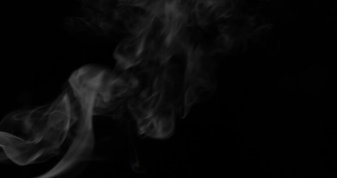 Detailed slow motion rising smoke isolated on black background. Cinematic fog overlay with soft swirling motion, ideal for VFX compositing, transitions and atmosphere.