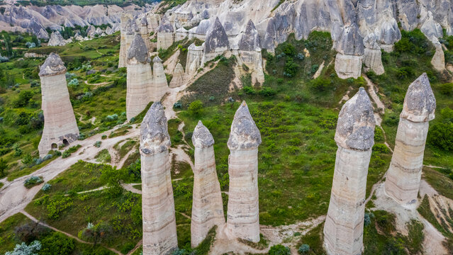 High angle aerial view of unique phallic fairy chimney rock formations in Love Valley, scenic geological canyon landscape near Goreme in the Cappadocia region, Turkey