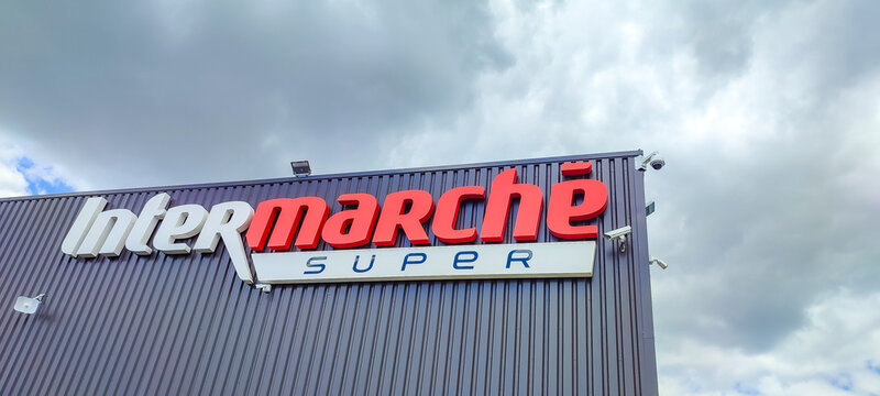 Chatellerault, France - May 15, 2026: Intermarche Super store sign on building exterior with cloudy sky in background, modern retail architecture
