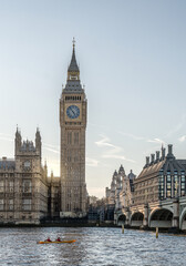 Fototapeta premium Iconic Big Ben Elizabeth Tower and Westminster Bridge over River Thames with people kayaking at sunset, London, UK