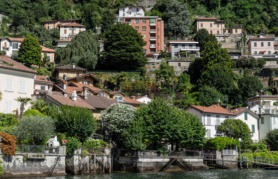 Houses building architecture on lake Como Italy city on water.