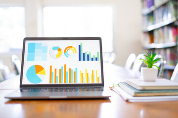 Fototapeta premium Business Analytics Dashboard on Laptop Screen in Library Study Environment 