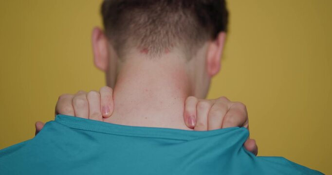 Man demonstrates neck stretching techniques for improved flexibility and relaxation in a bright indoor setting