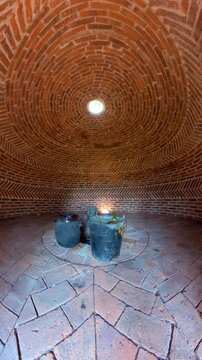 Brick interior of a traditional mayan temazcal prepared for a purification sweat lodge ritual
