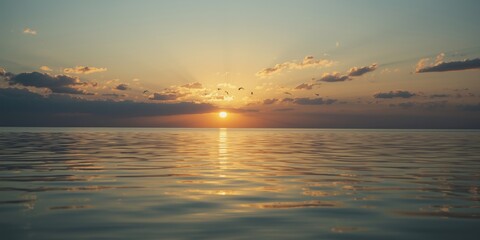 Obraz premium Calm sea horizon at golden hour with flying birds and glowing clouds reflected in placid water