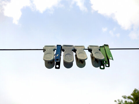 Colorful Clothespins Hanging on Laundry Line Outdoors