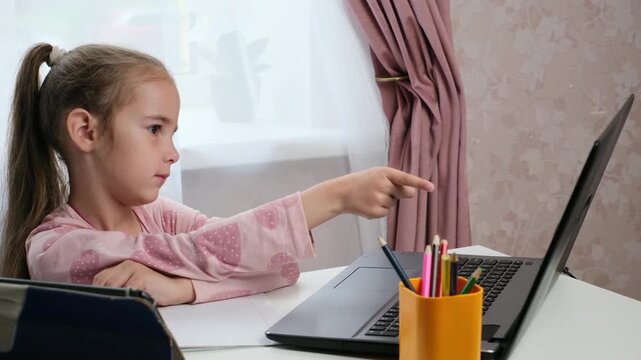 Child studying at home with hybrid learning education concept