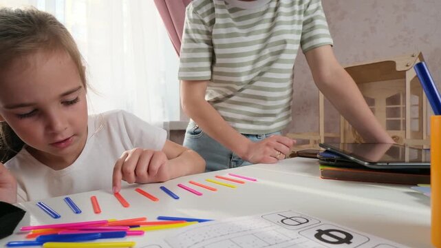Child focused studying at home with mum guided independence learning