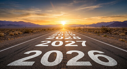 Fototapeta premium 2026 future journey concept with years painted on highway leading to desert sunset