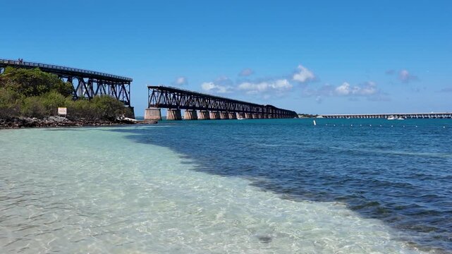 Iconic railroad bridge at Bahia Honda State Park with view of the tropical beach and turquoise water, Florida Keys