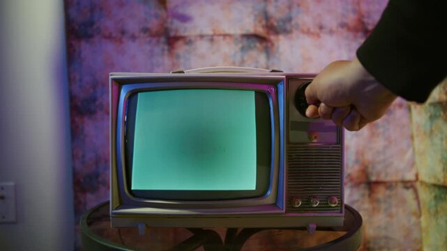 A retro television displaying grainy black and white static in a cozy, vintage room. This nostalgic setup evokes memories of past broadcasts and captures glitch art aesthetics perfect for Halloween