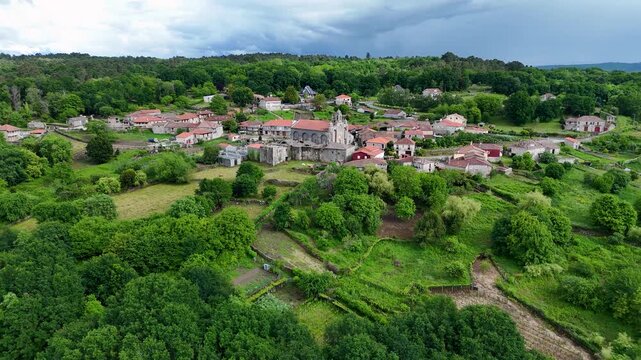 Aerial drone flying around historic church in Santa Marina de Augas Santas