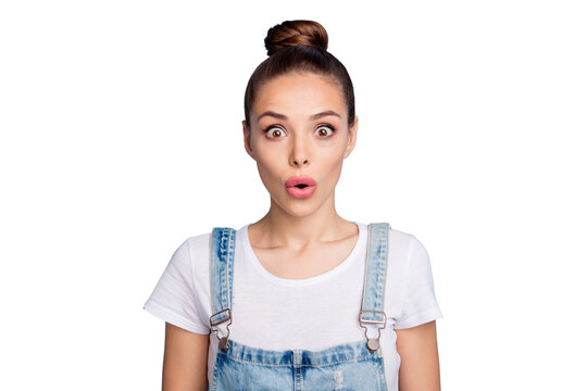 Portrait of impressed lady looking with opened mouth wearing white t-shirt denim jeans overall isolated over blue background