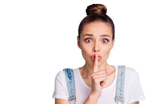 Close up photo of frustrated girl with lips pouted plump wearing white t-shirt denim jeans overalls isolated over blue background