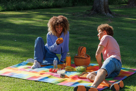 Young couple enjoying a picnic in the park, connecting and relaxing outdoors