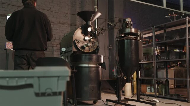 Coffee roasting specialist working with industrial equipment