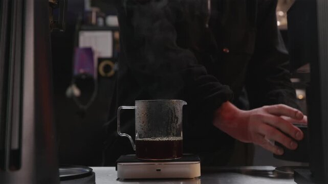 Professional coffee roaster brewing hand brew to check roast quality