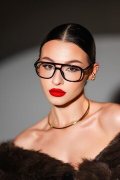 Luxurious Woman With Striking Features. Stylish Lady Exudes Sophistication Under Dramatic Studio Lighting