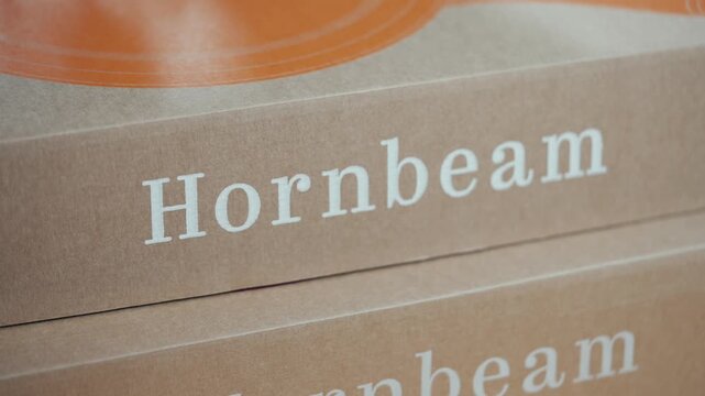 Close-up of branded cardboard boxes labeled 'Hornbeam'. Text is crisp, centered, and cleanly printed. Boxes stack neatly, hinting at organized storage. Ideal for product packaging, eco-branding